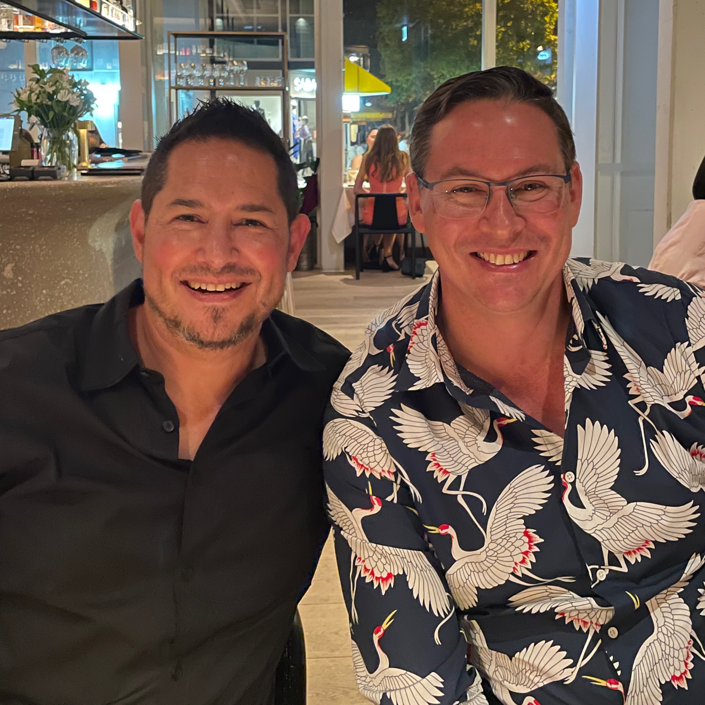 Macca and Martin smiling together at dinner